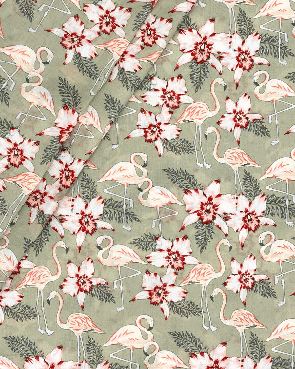 Folded flamingo floral cotton fabric in sage green, lightweight woven material.