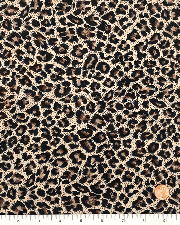 Leopard print fabric shown with ruler and penny for scale