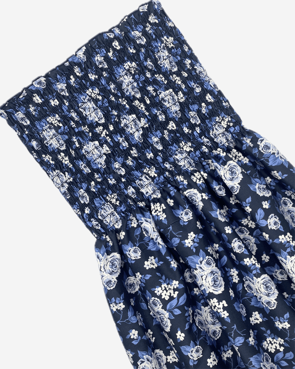 Navy blue floral smocked fabric detail with elastic shirring.