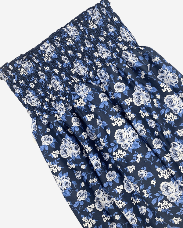 Girls navy blue and white floral cotton smocked fabric, 27” wide with shirred bodice.