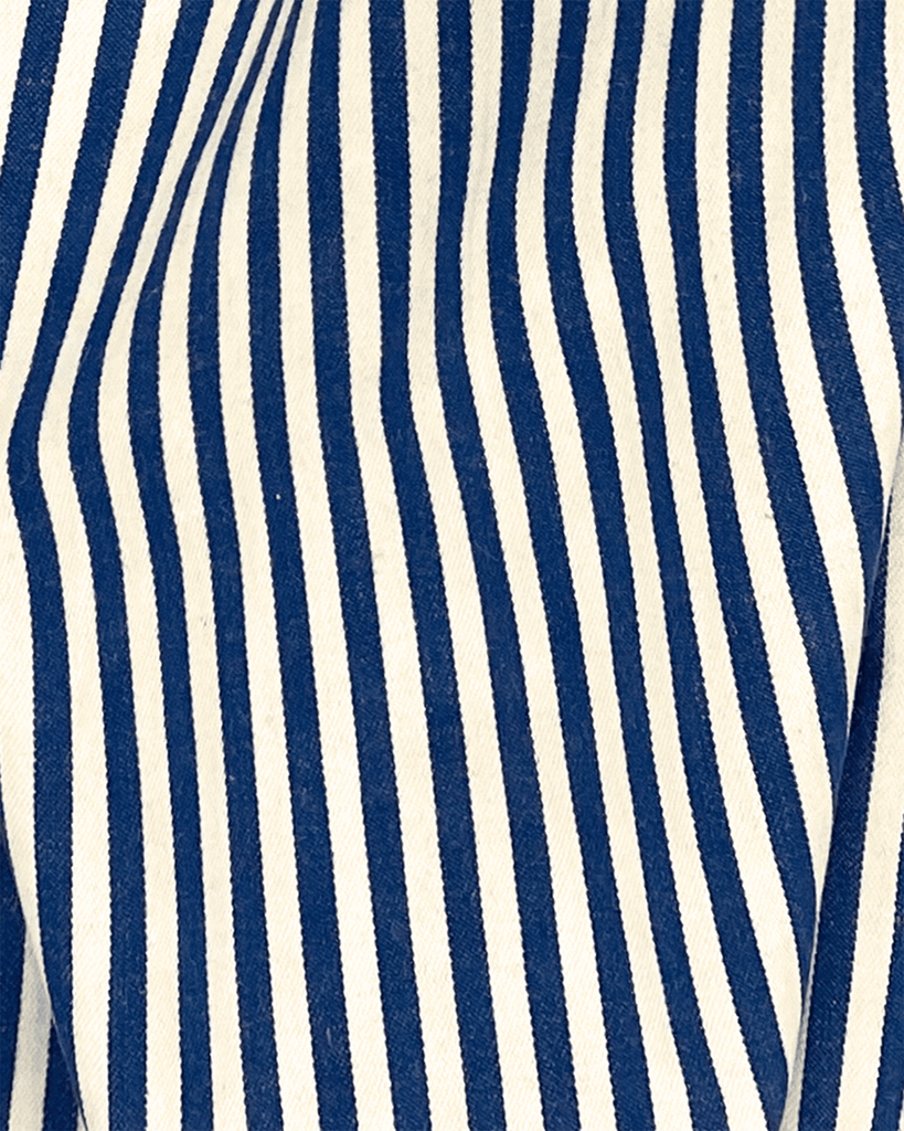 Draped navy and cream striped cotton twill fabric with crisp texture shown magnifies