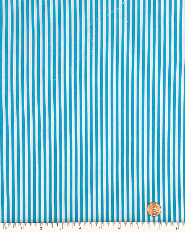 Sky blue and white striped cotton fabric with ruler and penny for scale