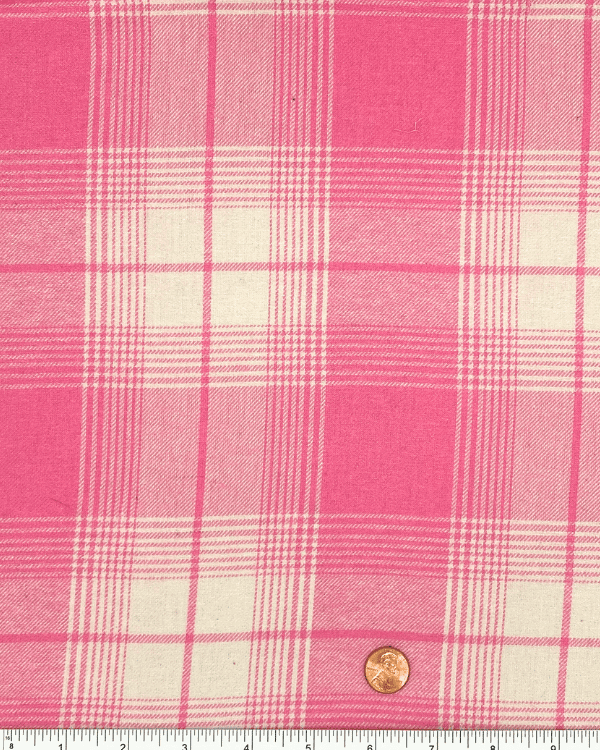 Pink plaid cotton flannel fabric with ruler and penny for scale reference