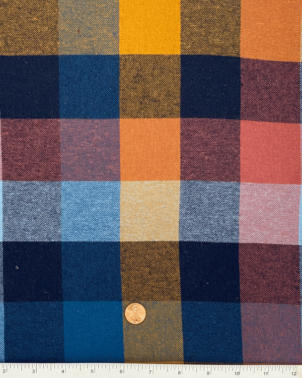 Plaid flannel cotton fabric in navy, rust, mustard with ruler scale – 58” wide.