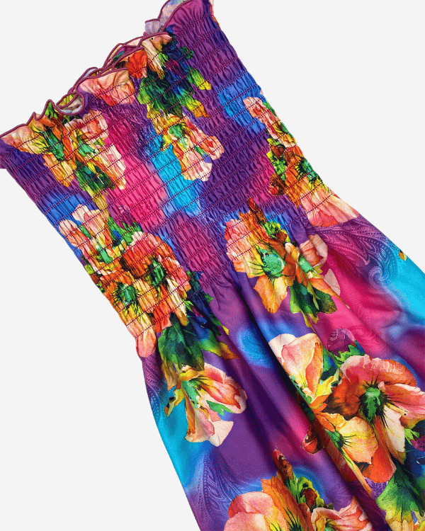 Pre-shirred tropical floral cotton fabric laid flat, close-up of smocking and colors