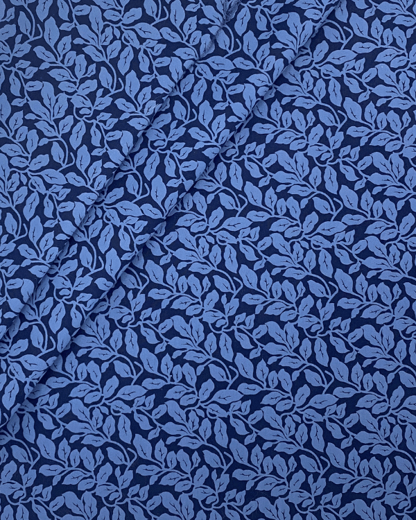 Blue leaf print cotton fabric folded for apparel sewing projects