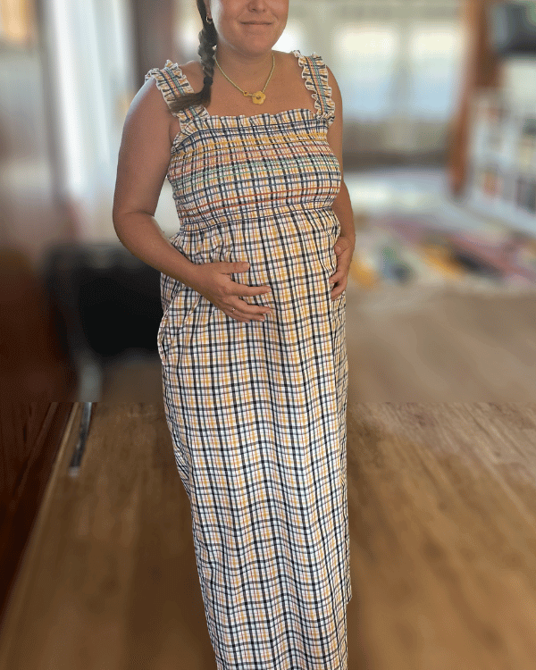 Pregnant Model wearing yellow navy plaid smocked sundress maxi with straps