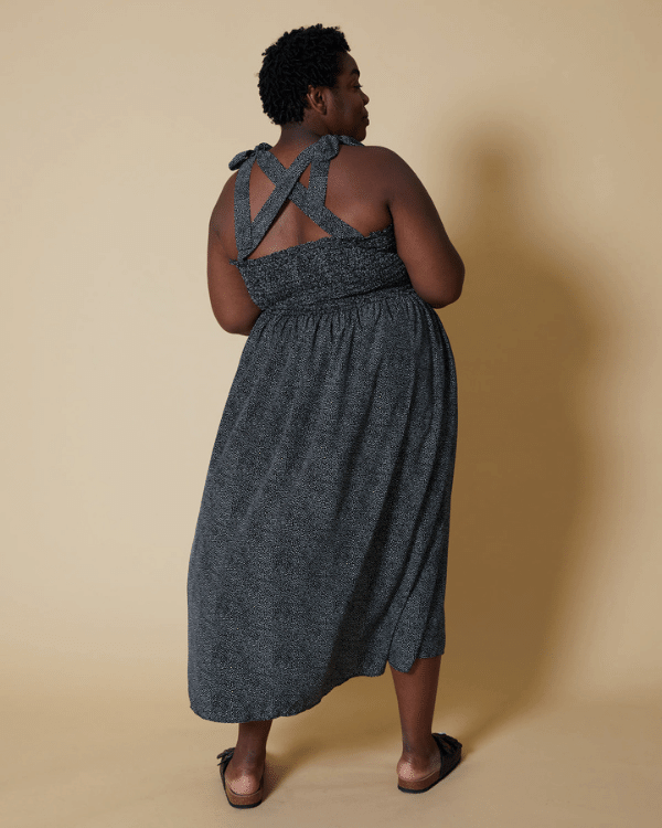 Back View of a Plus Size Model wearing Black and White Pebble Polka Dot Shirred Halter Dress made from a Threadymade Ready to Sew Shirred Dress Sewing Project Kit