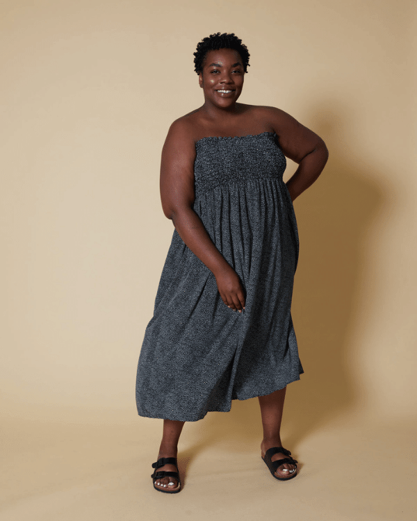 Front View of a Plus Size Model wearing a Sleeveless Black and White Pebble Polka Dot Shirred Midi Dress made from a Threadymade Ready to Sew Shirred Dress Sewing Project Kit